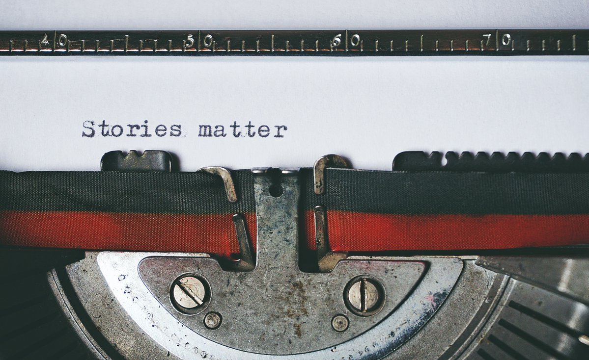 A sheet of paper in a typewriter saying "Stories matter."