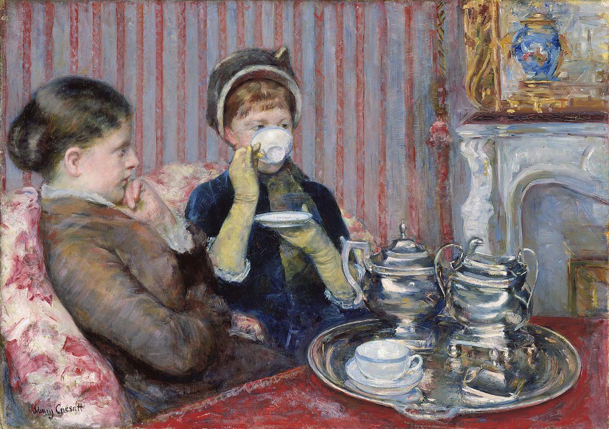Mary Cassatt's painting 'Tea' from 1880. Two ladies sit close on a floral sofa. One (hatless) broods or daydreams, as the other (in bonnet) looks away over the rim of the tea cup from which she sips. Before them is a polished silver tea set and tray. Behind them striped wallpaper, gilt-framed mirror and blue and gold vase.